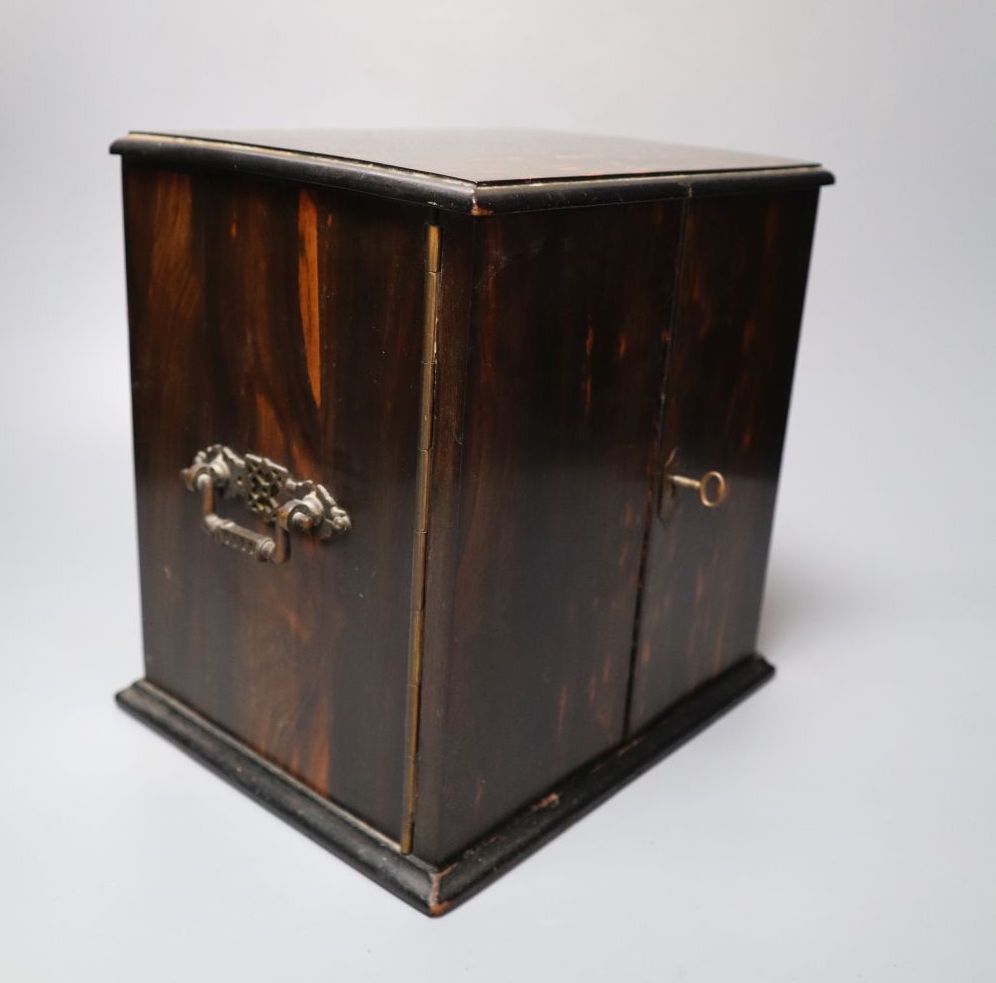 A Victorian coromandel cabinet with three drawers and two doors, with key, 22cm wide